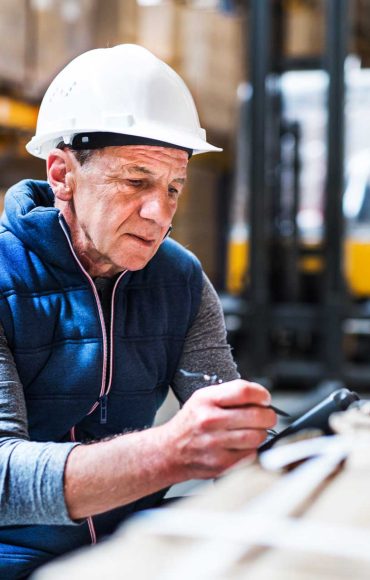 portrait-of-a-senior-male-warehouse-worker-or-a-su-F59H23T.jpg